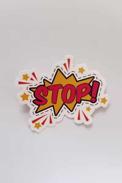 red and yellow stop sticker